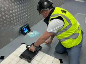 Expert from Fortress Stabilisation Europe conducting advanced concrete scanning with GPR equipment while analysing carbon fibre reinforcement requirements